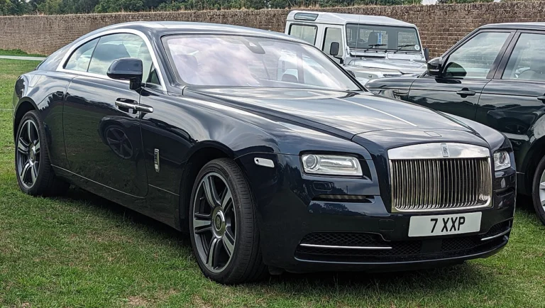 Dark Rolls-Royce Wraith Coupe displayed on grass