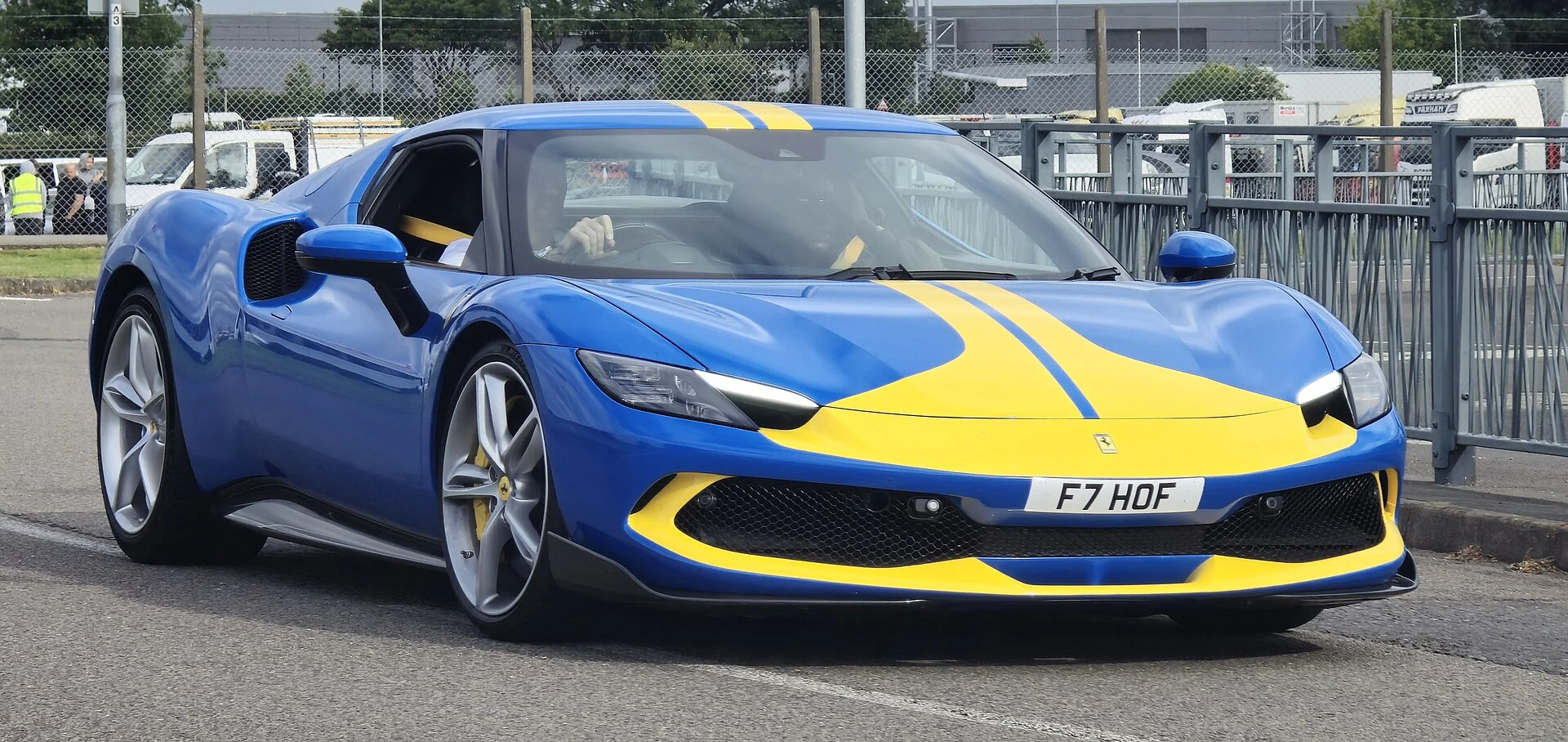 Blue Ferrari 296 Assetto Fiorano with a yellow racing stripe