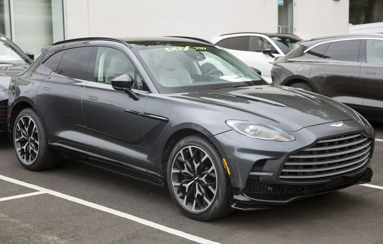 Gray Aston Martin DBX707 SUV parked outside a showroom