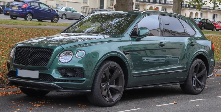 Green Bentley Bentayga V8 parked beside a street