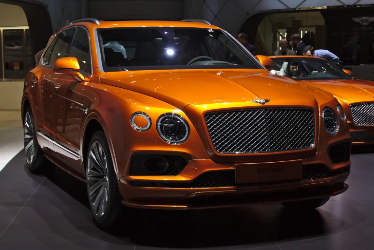 Orange Bentley Bentayga Speed on an indoor motor-show display