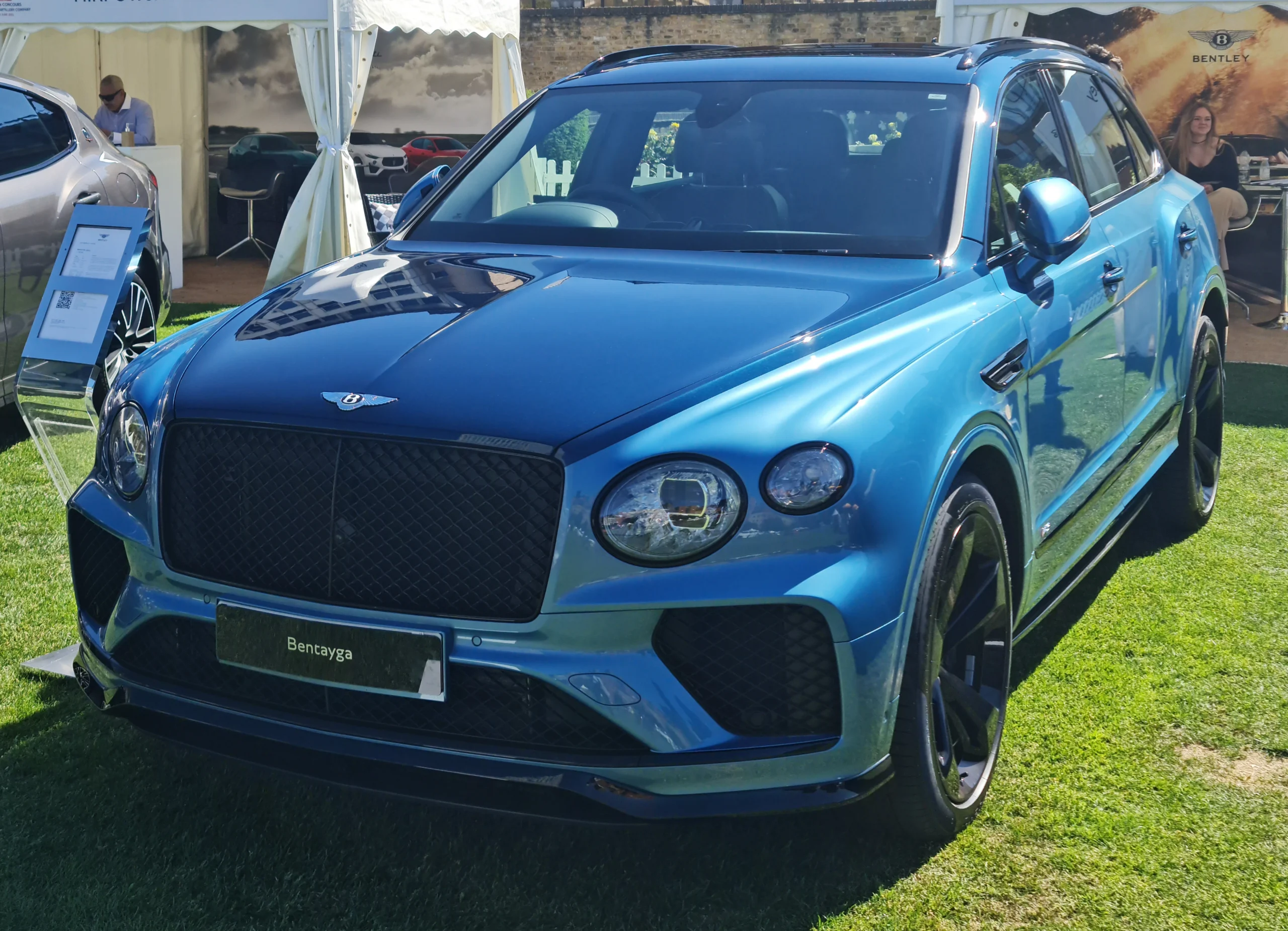 Blue Bentley Bentayga Speed displayed on grass