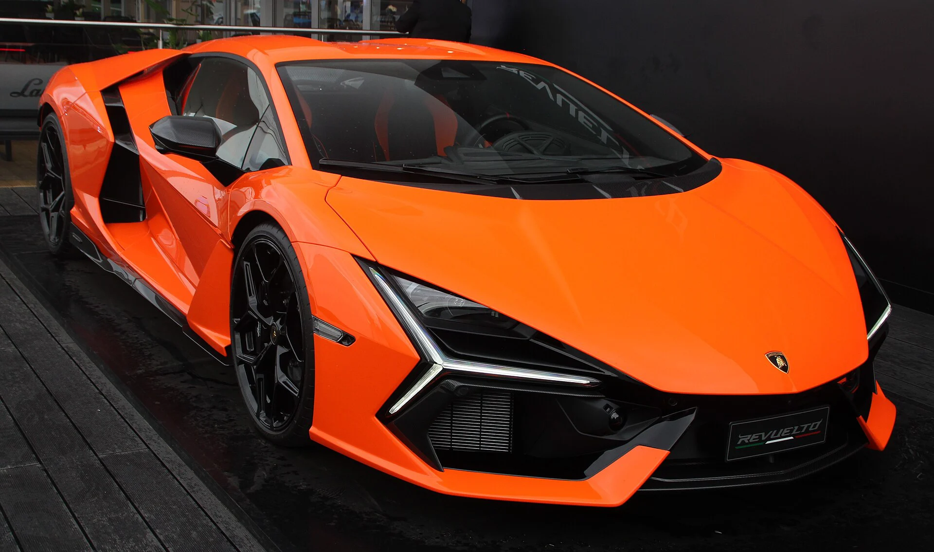 Orange Lamborghini Revuelto on an indoor display