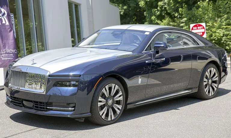 Blue and silver Rolls-Royce Spectre coupe, front three-quarter view