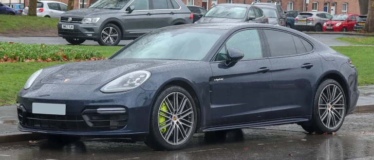Dark gray Porsche Panamera 4 E-Hybrid parked beside a street