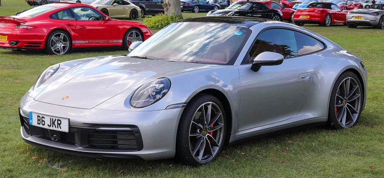 Silver Porsche 911 Carrera S Coupe displayed on grass