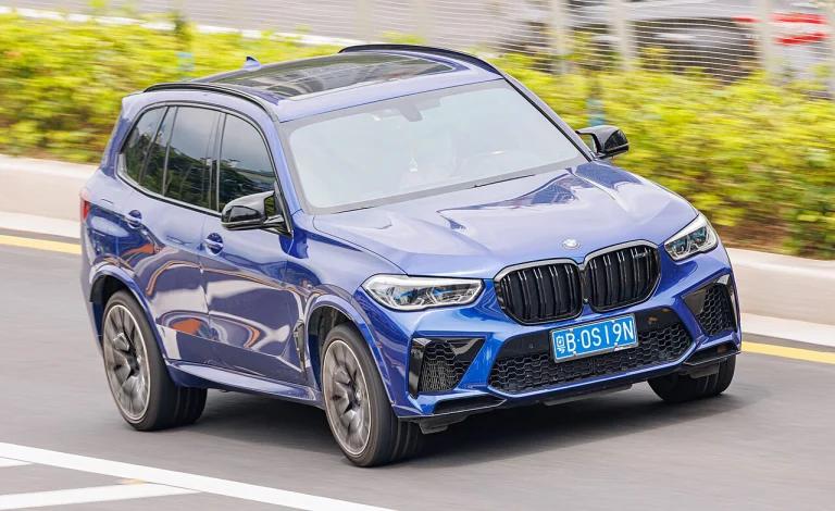 Blue BMW X5 M SUV, front three-quarter view