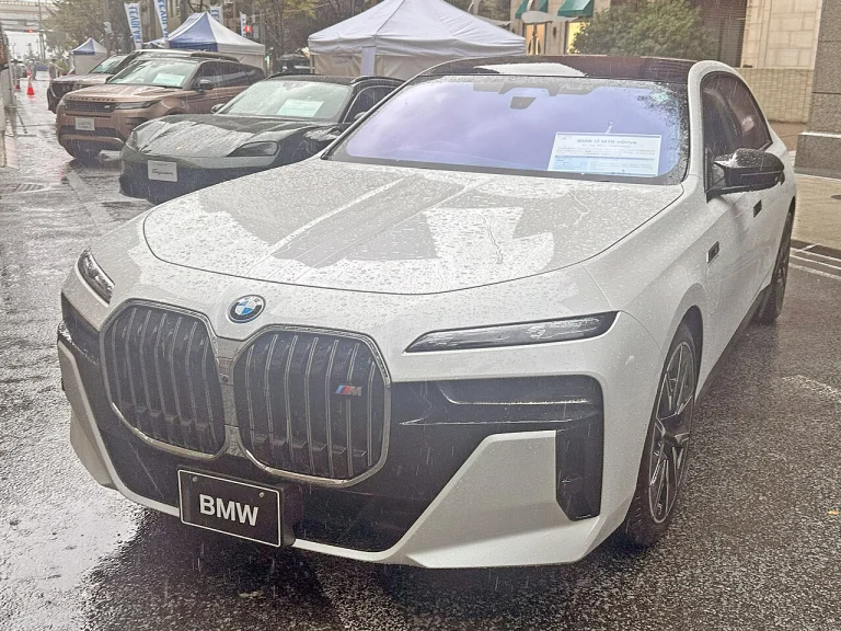 White BMW i7 M70 sedan, front three-quarter view
