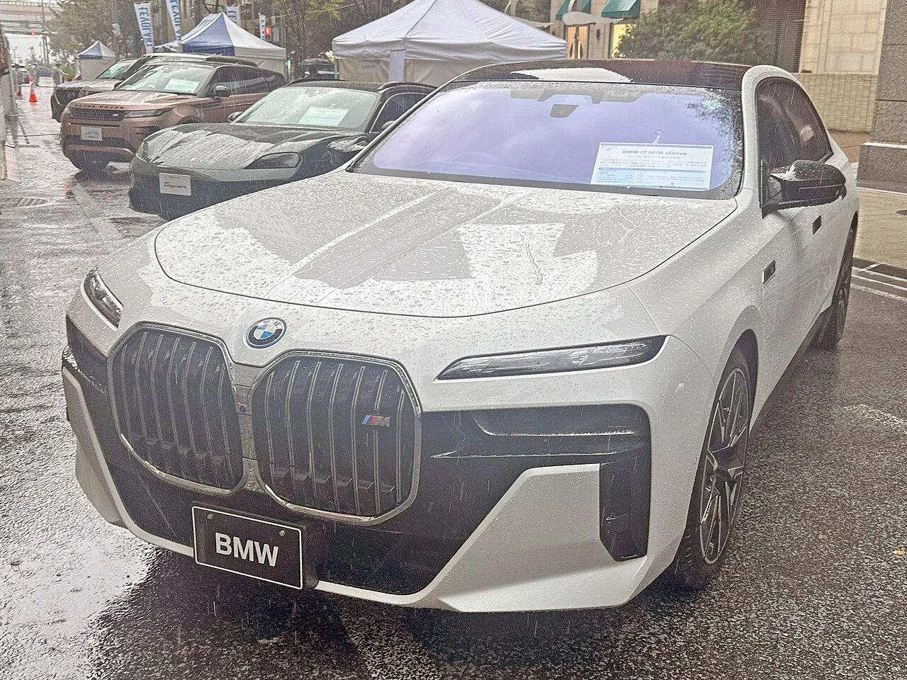 White BMW i7 M70 sedan, front three-quarter view