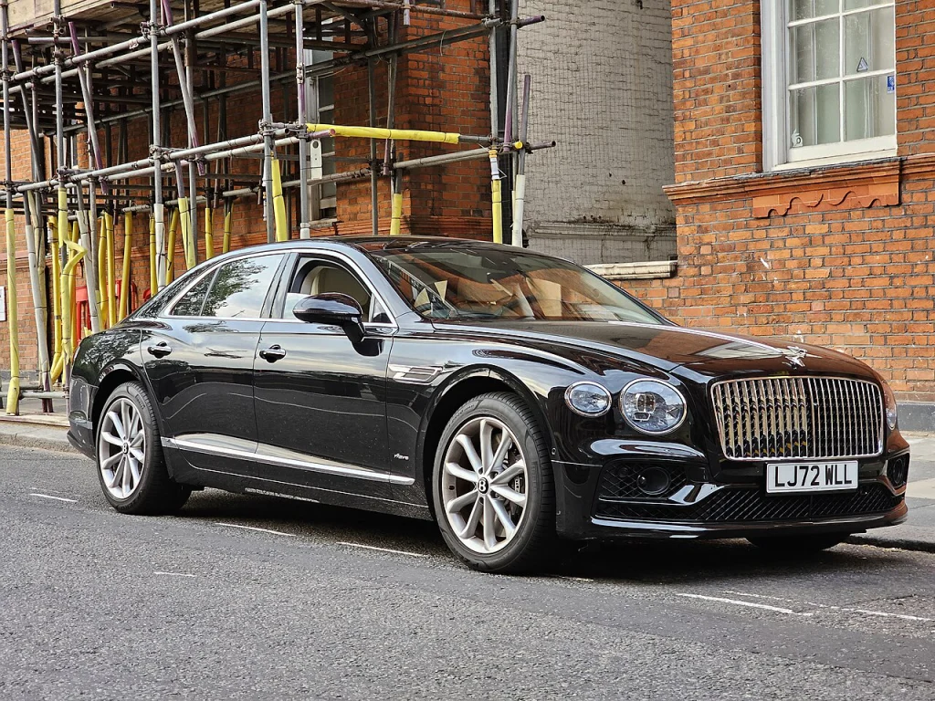 Black Bentley Flying Spur V8 Azure sedan parked beside a street
