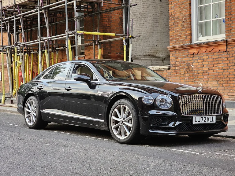 Black Bentley Flying Spur V8 Azure sedan parked beside a street