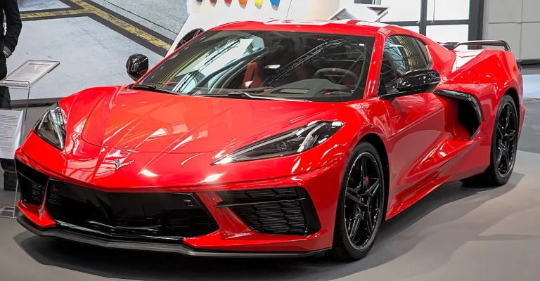 Red C8 Chevrolet Corvette displayed indoors