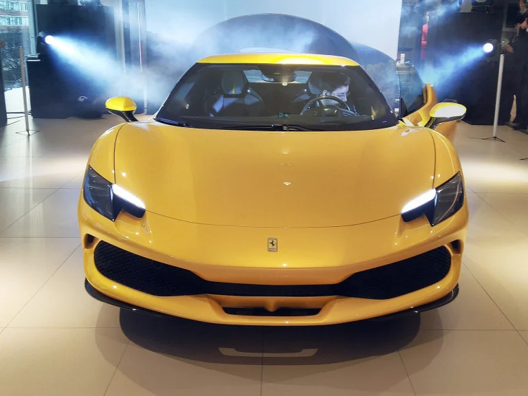 Front view of a yellow Ferrari 296 GTB on display