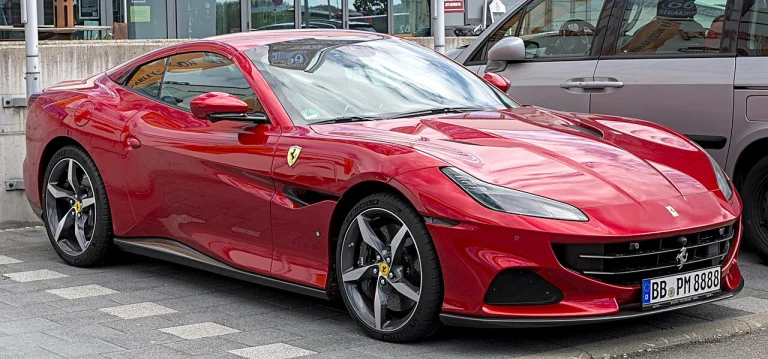 Red Ferrari Portofino M convertible with its roof lowered