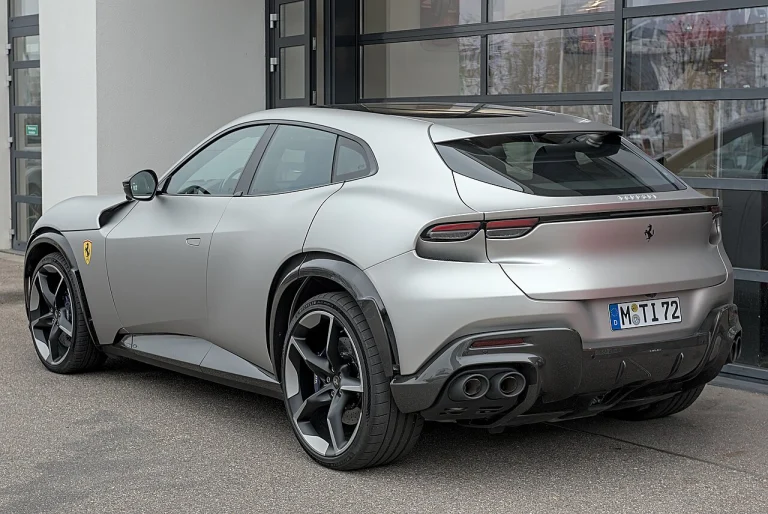 Rear three-quarter view of a silver Ferrari Purosangue