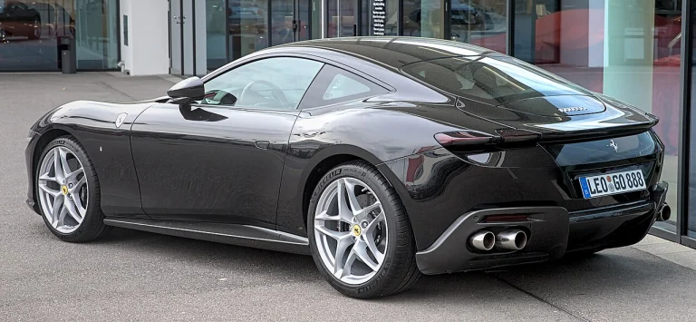 Rear three-quarter view of a dark Ferrari Roma coupe