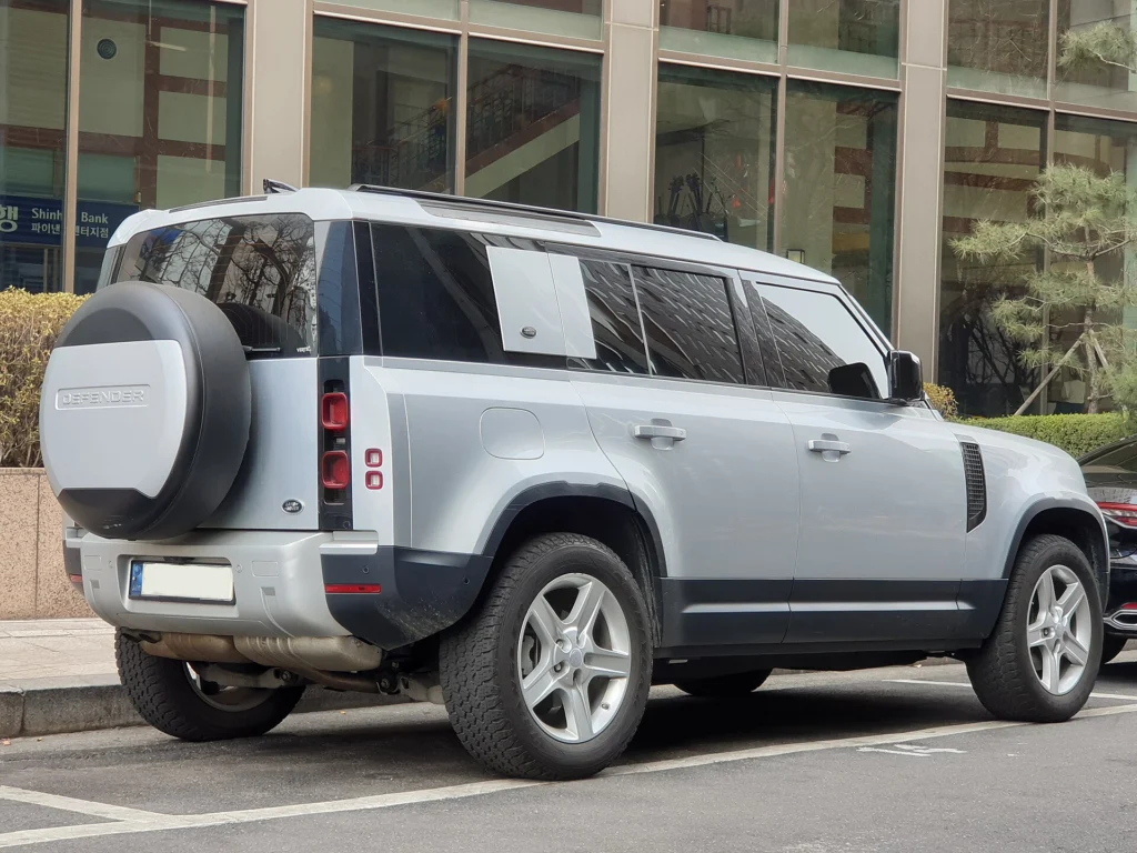 Rear three-quarter view of a silver Land Rover Defender 110