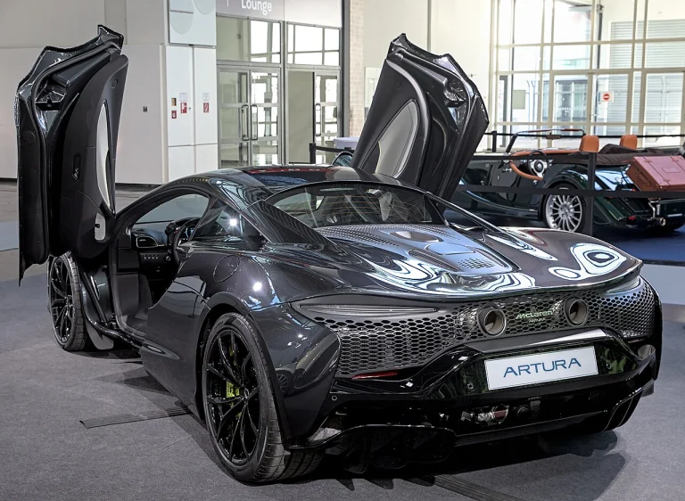 Dark McLaren Artura displayed with both doors raised