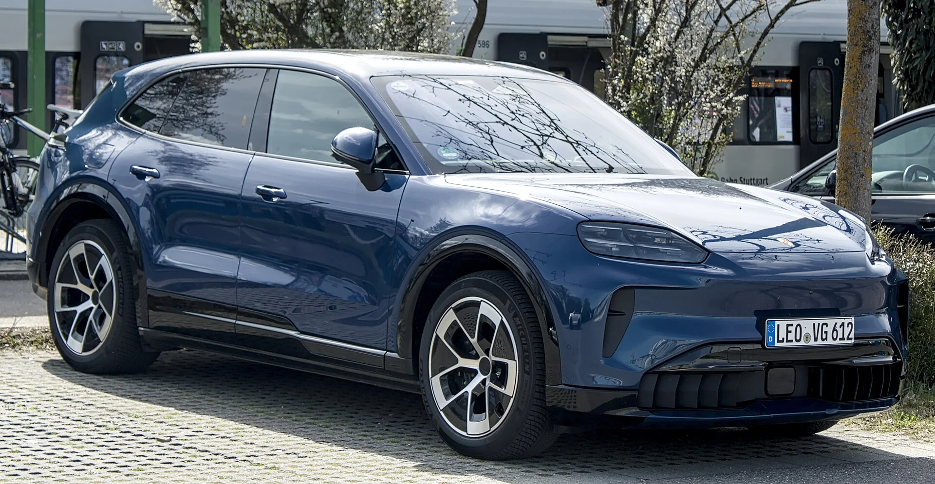 Blue Porsche Cayenne Electric, front three-quarter view