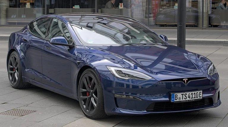 Blue Tesla Model S Plaid sedan parked outside