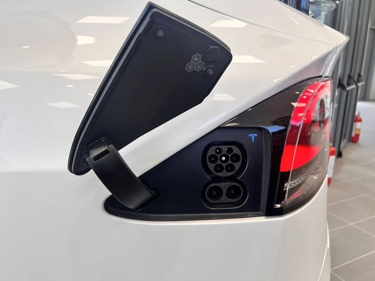 Open charging port on a white Tesla Model X Plaid